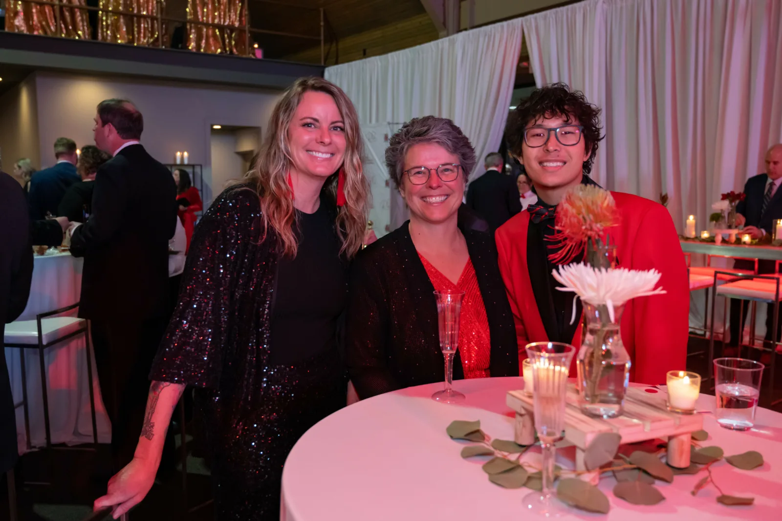 Riley supporters in front of a table at the Riley Red event