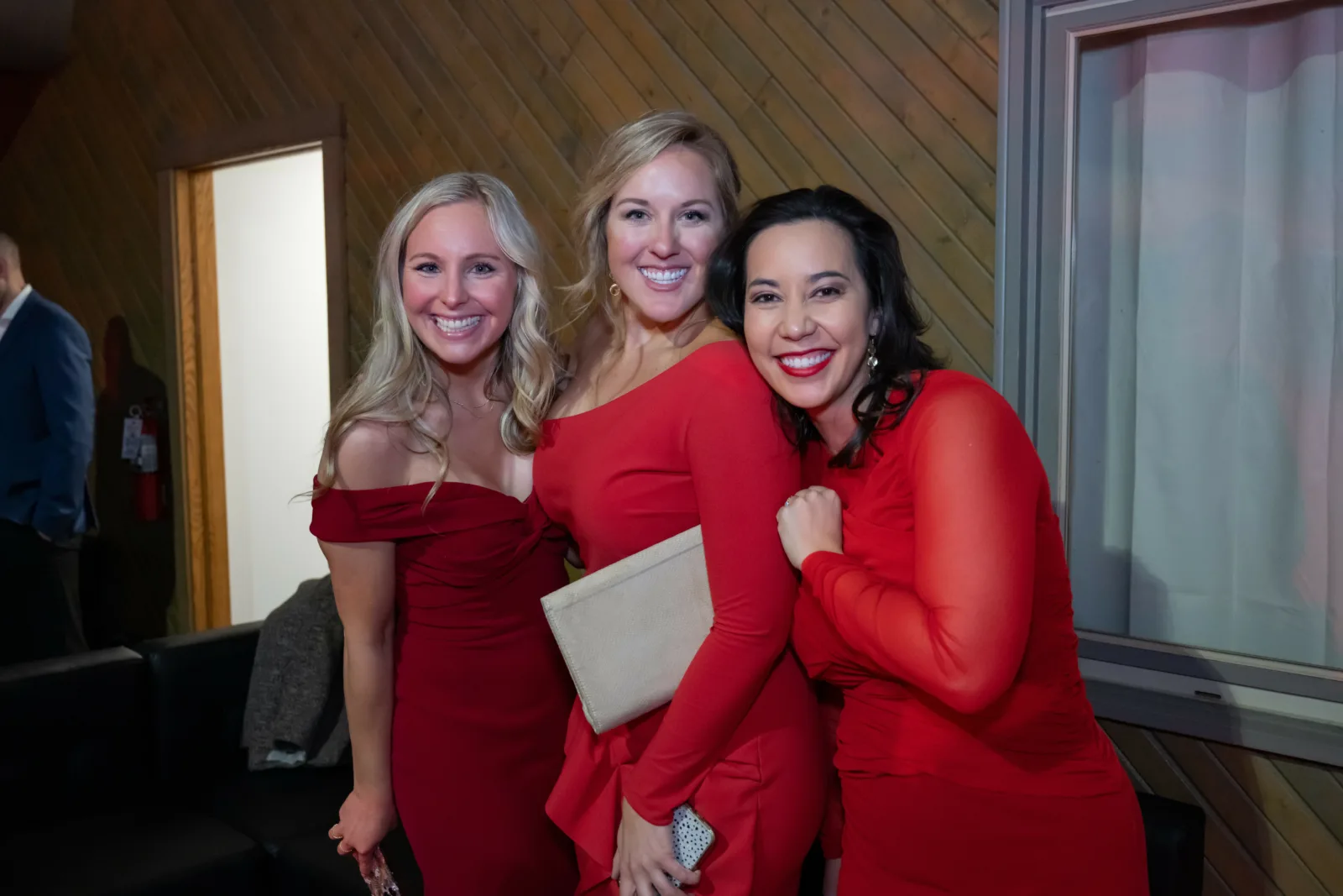 Three women Riley supporters posing for photo at Riley Red event