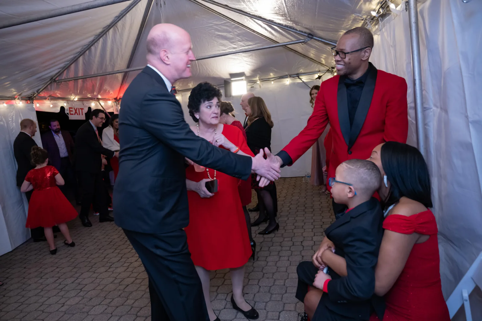 Riley Red event, Gil Peri shaking hands with attendees.