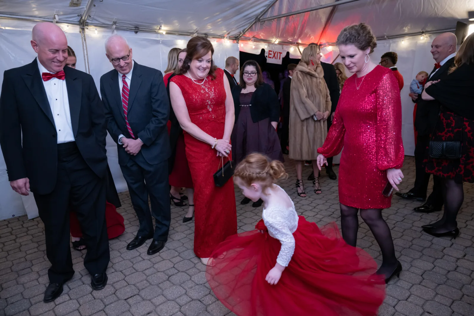 Red For Our Kids event. Little girl twirling her dress.