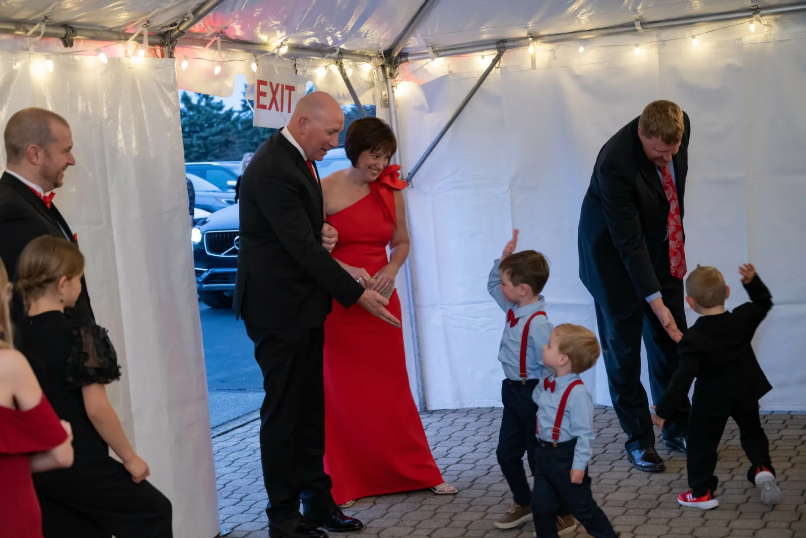 Riley kids high-fiving couple as the enter a tent at Riley Red event