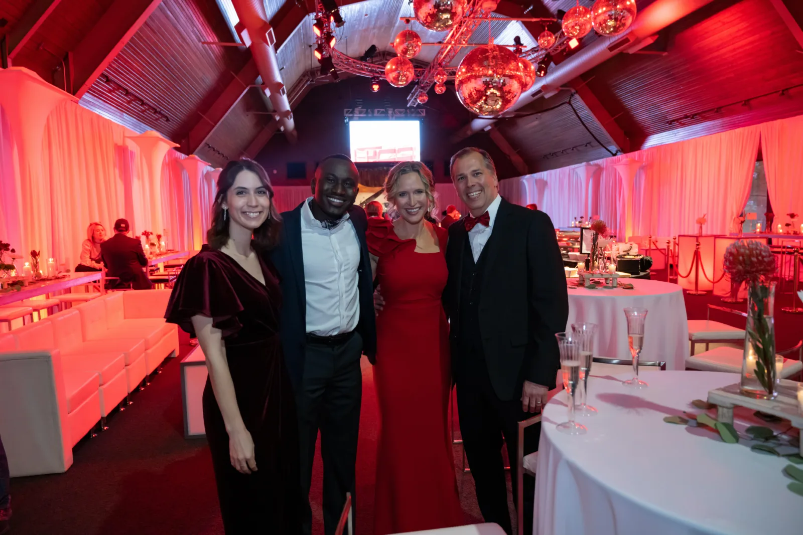 Group of four posing at the Riley Red event