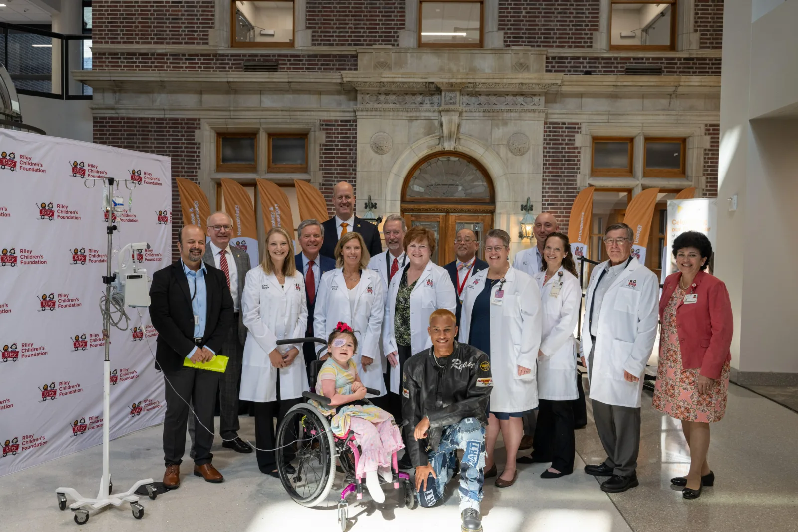Walther Cancer Foundation researchers, guests, and administrators pose for photo on stage