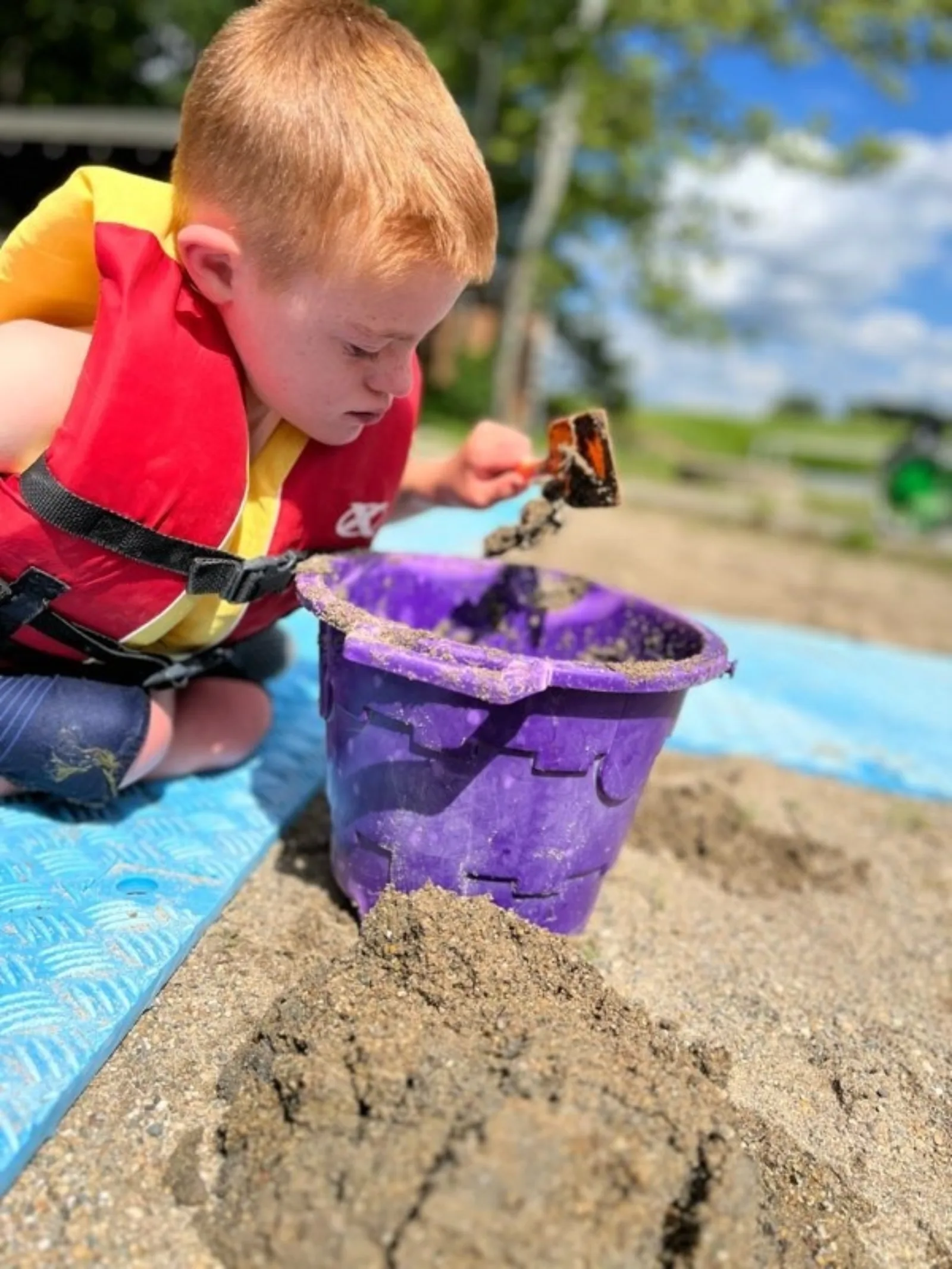 Luke plays in sand at the beach
