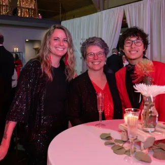 Riley supporters in front of a table at the Riley Red event