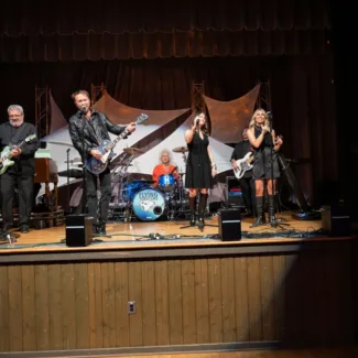 Band on stage at Riley Red event