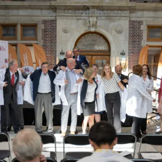 Walther Cancer Foundation event white coat presentation on stage