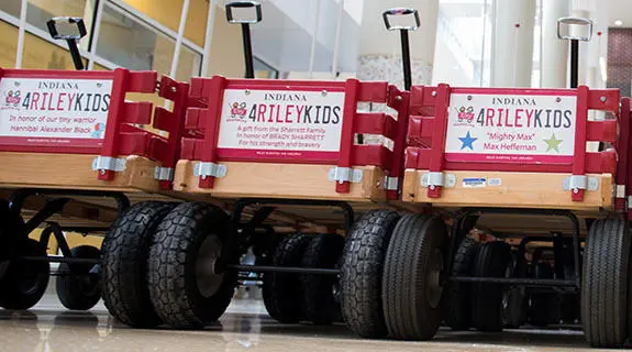 Three Riley red wagons in Simon Family Tower lobby.
