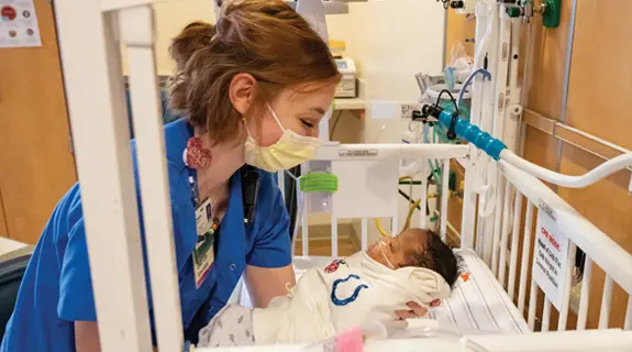 A nurse holds baby