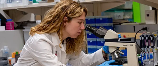 Riley researcher looking through microscope