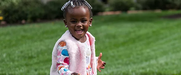 Riley kid Carlie Evans walking in the grass
