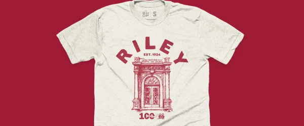 A heather gray shirt with a picture of the original entrance to Riley Children's Health with Riley est. 1924 and the number 100
