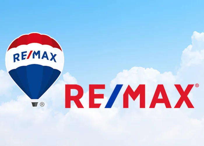 REMAX  logo with hot air balloon with clouds in the background