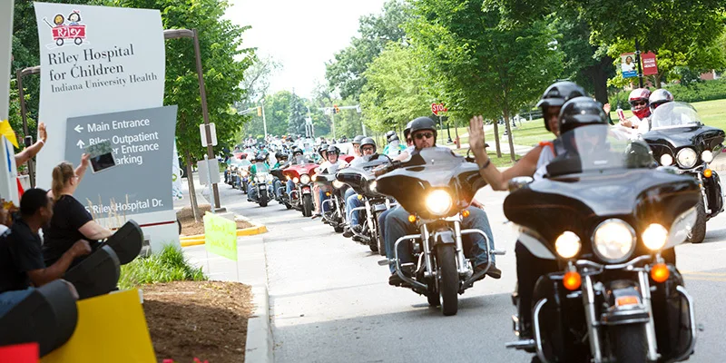 Motorcycles driving past Riley Hospital