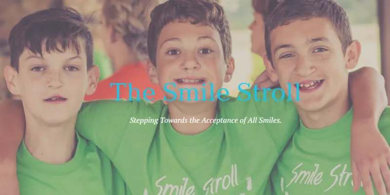 Three boys are wearing green t-shirts. They are smiling and look happy.