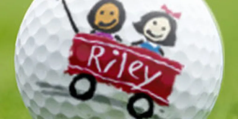 A golf ball with the Riley logo printed on it